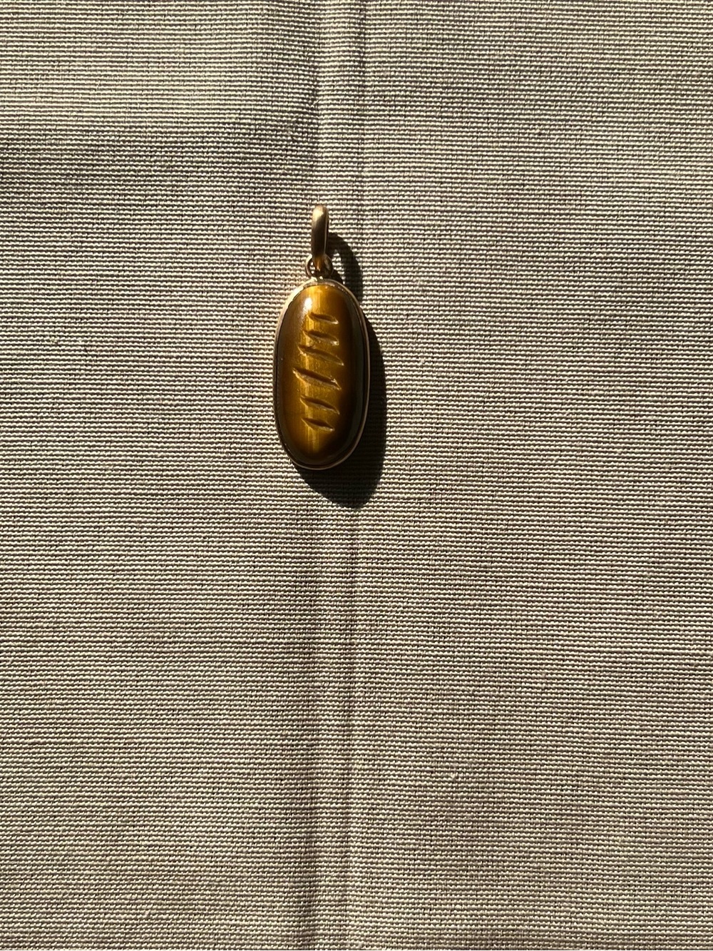 21K Hand Carved Tigers Eye Bread Pendant